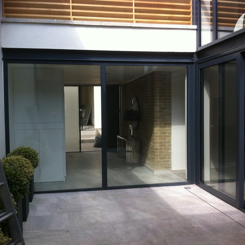 Floor-to-ceiling sliding doors opening to courtyard in Rotherhithe