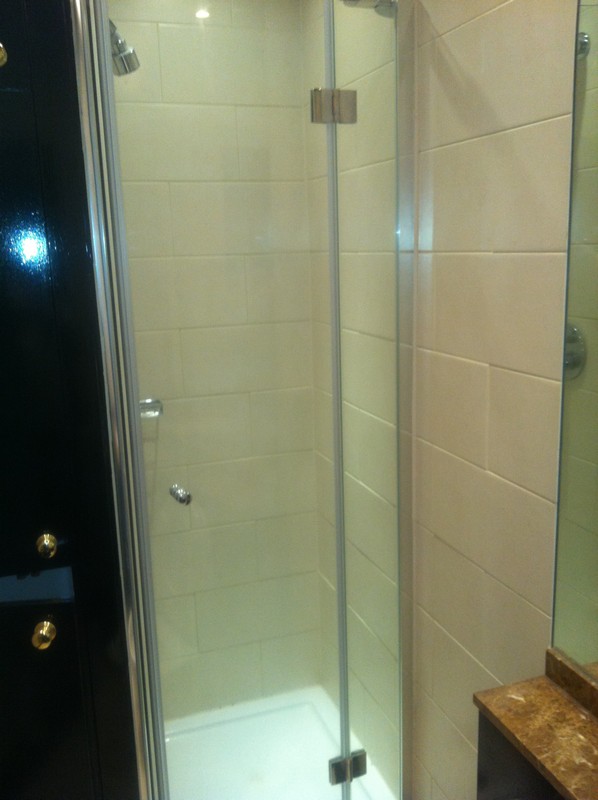 Frameless glass shower enclosure with chrome fittings in Rotherhithe