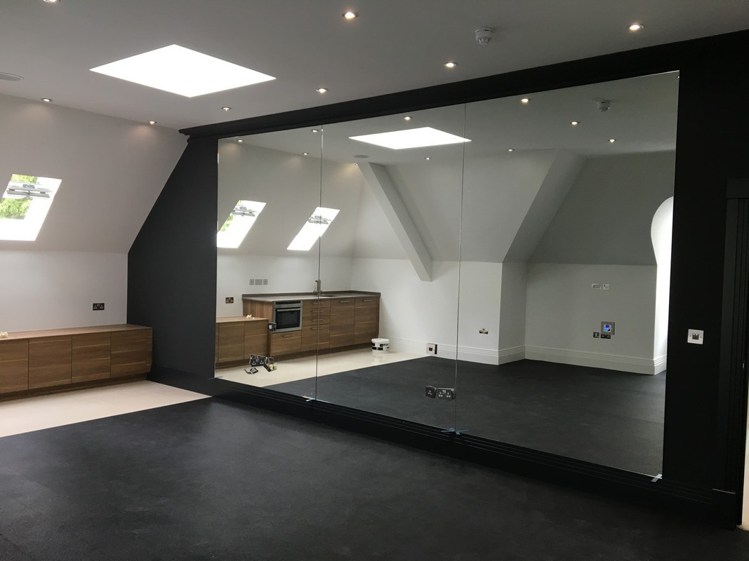Frameless glass wall dividing loft conversion in Rotherhithe
