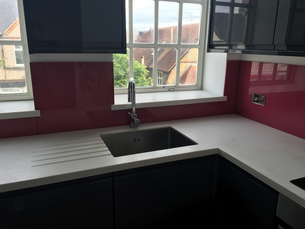 Deep plum coloured glass splashback in modern Rotherhithe kitchen